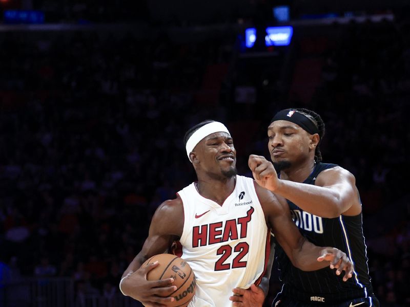 MIAMI, FLORIDA - OCTOBER 23: Jimmy Butler #22 of the Miami Heat drives past Wendell Carter Jr. #34 of the Orlando Magic during the second half at Kaseya Center on October 23, 2024 in Miami, Florida. NOTE TO USER: User expressly acknowledges and agrees that, by downloading and or using this photograph, User is consenting to the terms and conditions of the Getty Images License Agreement. (Photo by Carmen Mandato/Getty Images)