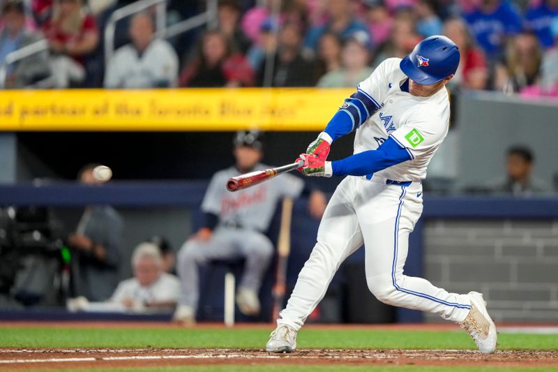 May 17, 2025; Toronto, Ontario, CAN; Toronto Blue Jays outfielder Daulton Varsho (5) doubles against the Detroit Tigers during the ninth inning in their MLB game at Rogers Centre. Mandatory Credit: Kevin Sousa-Imagn Images