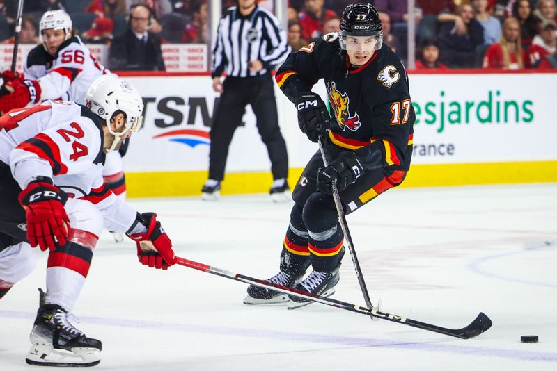 Dec 9, 2023; Calgary, Alberta, CAN; Calgary Flames center Yegor Sharangovich (17) controls the puck against the New Jersey Devils during the second period at Scotiabank Saddledome. Mandatory Credit: Sergei Belski-USA TODAY Sports