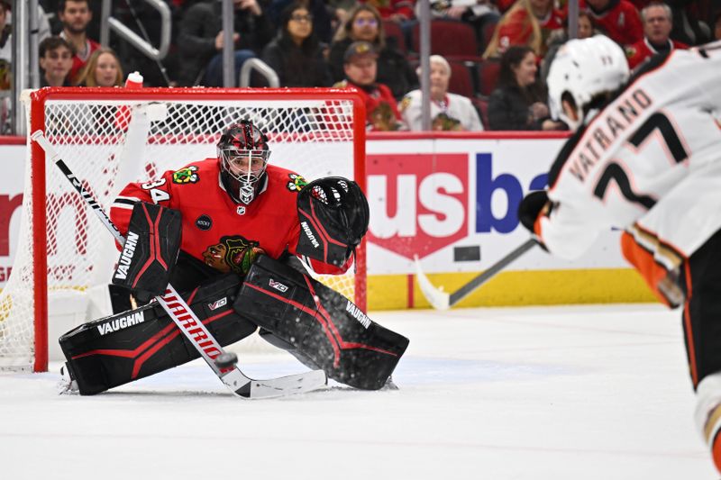 Dec 7, 2023; Chicago, Illinois, USA; Chicago Blackhawks goaltender Petr Mrazek (34) tracks a shot from Anaheim Ducks forward Frank Vatrano (77) in the second period at United Center. Mandatory Credit: Jamie Sabau-USA TODAY Sports