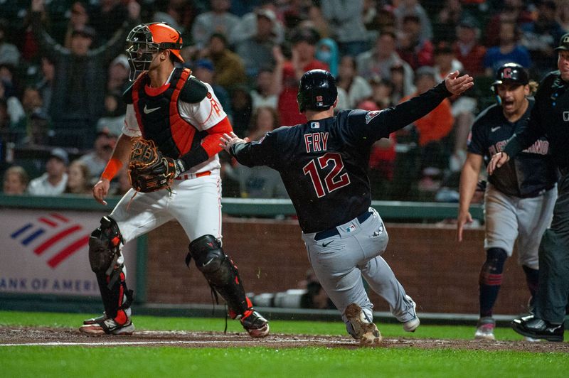 Sep 12, 2023; San Francisco, California, USA; Cleveland Guardians catcher David Fry (12) slides into home plate during the sixth inning against the San Francisco Giants at Oracle Park. Mandatory Credit: Ed Szczepanski-USA TODAY Sports