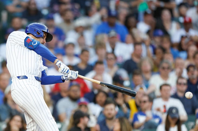 May 21, 2024; Chicago, Illinois, USA; Chicago Cubs outfielder Mike Tauchman (40) hits an RBI-single against the Atlanta Braves during the second inning at Wrigley Field. Mandatory Credit: Kamil Krzaczynski-USA TODAY Sports