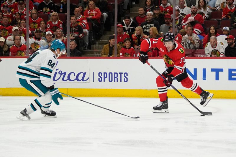 Oct 17, 2024; Chicago, Illinois, USA; San Jose Sharks defenseman Jan Rutta (84) defends Chicago Blackhawks left wing Taylor Hall (71) during the third period at United Center. Mandatory Credit: David Banks-Imagn Images