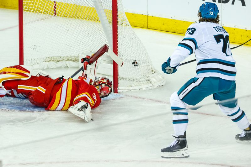 Apr 13, 2025; Calgary, Alberta, CAN; San Jose Sharks center Tyler Toffoli (73) scores a goal against Calgary Flames goaltender Dustin Wolf (32) during the first period at Scotiabank Saddledome. Mandatory Credit: Sergei Belski-Imagn Images