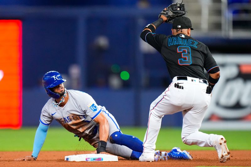 Jun 7, 2023; Miami, Florida, USA; Miami Marlins second baseman Luis Arraez (3) tags out Kansas City Royals right fielder MJ Melendez (1) during the fourth inning at loanDepot Park. Mandatory Credit: Rich Storry-USA TODAY Sports