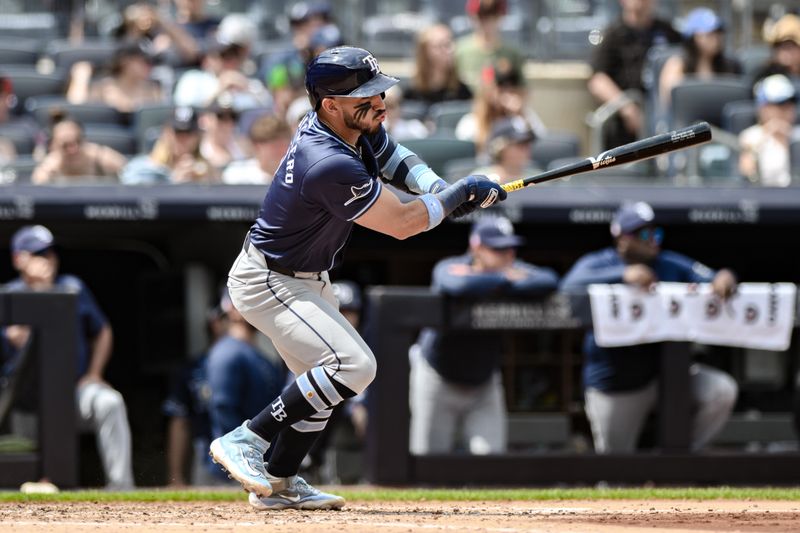 Jul 21, 2024; Bronx, New York, USA; Tampa Bay Rays shortstop José Caballero (7) hits a RBI single against the New York Yankees during the fourth inning at Yankee Stadium. Mandatory Credit: John Jones-USA TODAY Sports