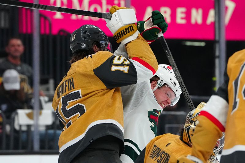 Apr 12, 2024; Las Vegas, Nevada, USA; Vegas Golden Knights defenseman Noah Hanifin (15) checks Minnesota Wild center Mason Shaw (15) during the first period at T-Mobile Arena. Mandatory Credit: Stephen R. Sylvanie-USA TODAY Sports