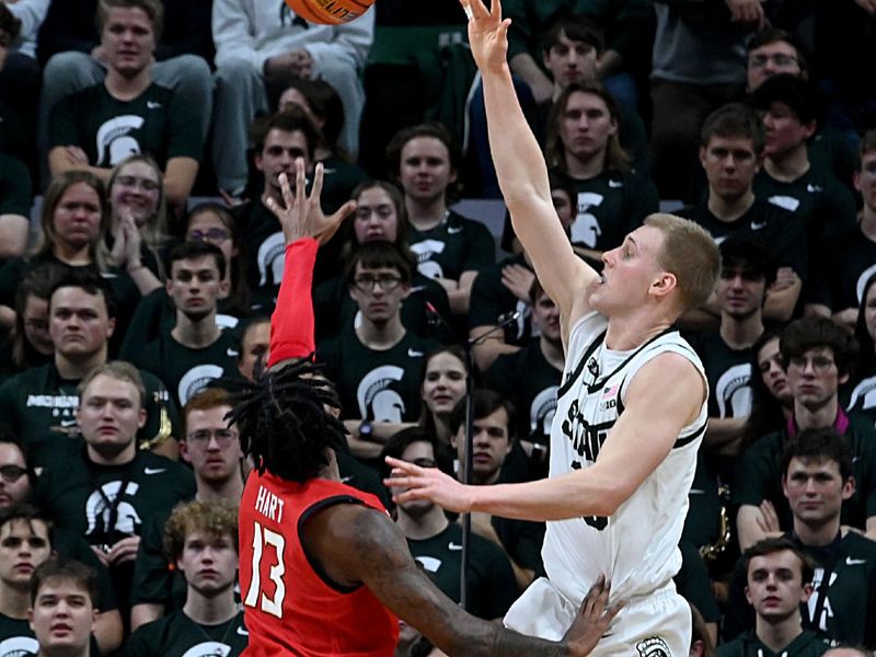 Feb 7, 2023; East Lansing, Michigan, USA; Michigan State Spartans forward Joey Hauser (10) shoots over Maryland Terrapins guard Hakim Hart (13) in the first half at Jack Breslin Student Events Center. Mandatory Credit: Dale Young-USA TODAY Sports