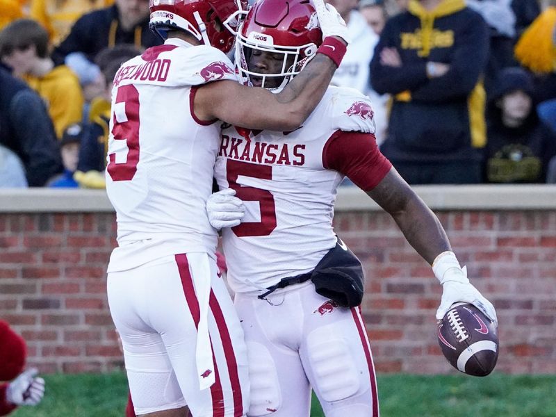 Nov 25, 2022; Columbia, Missouri, USA; Arkansas Razorbacks running back Raheim Sanders (5) celebrates with wide receiver Jadon Haselwood (9) after scoring against the Missouri Tigers during the first half at Faurot Field at Memorial Stadium. Mandatory Credit: Denny Medley-USA TODAY Sports