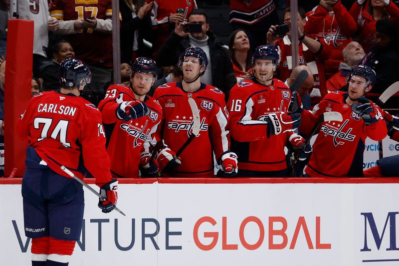 Jan 14, 2025; Washington, District of Columbia, USA; Washington Capitals defenseman John Carlson (74) celebrates with teammates after scoring a goal against the Anaheim Ducks in the first period at Capital One Arena. Mandatory Credit: Geoff Burke-Imagn Images