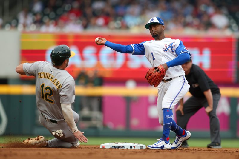 Jun 1, 2024; Atlanta, Georgia, USA; Atlanta Braves second baseman Ozzie Albies (1) attempts to turn a double play over Oakland Athletics shortstop Max Schuemann (12) in the second inning at Truist Park. Mandatory Credit: Brett Davis-USA TODAY Sports
