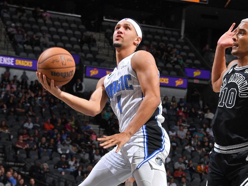 SAN ANTONIO, TX - MARCH 14: Jalen Suggs #4 of the Orlando Magic shoots the ball during the game against the San Antonio Spurs on March 14, 2023 at the AT&T Center in San Antonio, Texas. NOTE TO USER: User expressly acknowledges and agrees that, by downloading and or using this photograph, user is consenting to the terms and conditions of the Getty Images License Agreement. Mandatory Copyright Notice: Copyright 2023 NBAE (Photos by Michael Gonzales/NBAE via Getty Images)