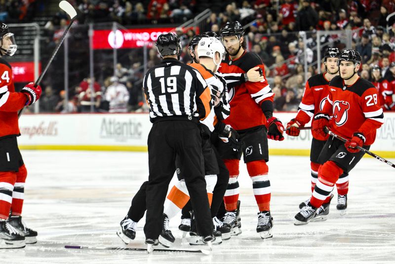 Jan 29, 2025; Newark, New Jersey, USA; Philadelphia Flyers right wing Matvei Michkov (39) and New Jersey Devils defenseman Brenden Dillon (5) react during the second period at Prudential Center. Mandatory Credit: John Jones-Imagn Images