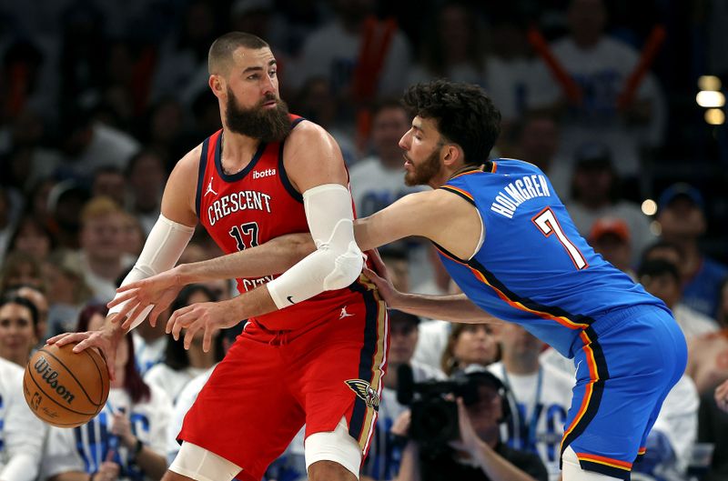 OKLAHOMA CITY, OKLAHOMA - APRIL 24:  Jonas Valanciunas #17 of the New Orleans Pelicans controls the ball as Chet Holmgren #7 of the Oklahoma City Thunder defends during the first half of game two of the first round of the NBA playoffs at Paycom Center on April 24, 2024 in Oklahoma City, Oklahoma. (Photo by Jamie Squire/Getty Images)