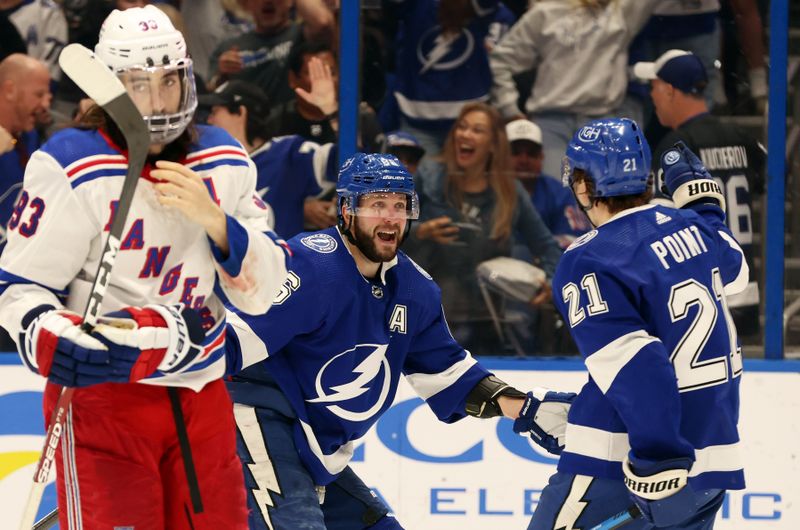 Mar 14, 2024; Tampa, Florida, USA; Tampa Bay Lightning center Brayden Point (21) is congratulated by right wing Nikita Kucherov (86) after he scored a goal for a hat trick against the New York Rangers during the third period at Amalie Arena. Mandatory Credit: Kim Klement Neitzel-USA TODAY Sports