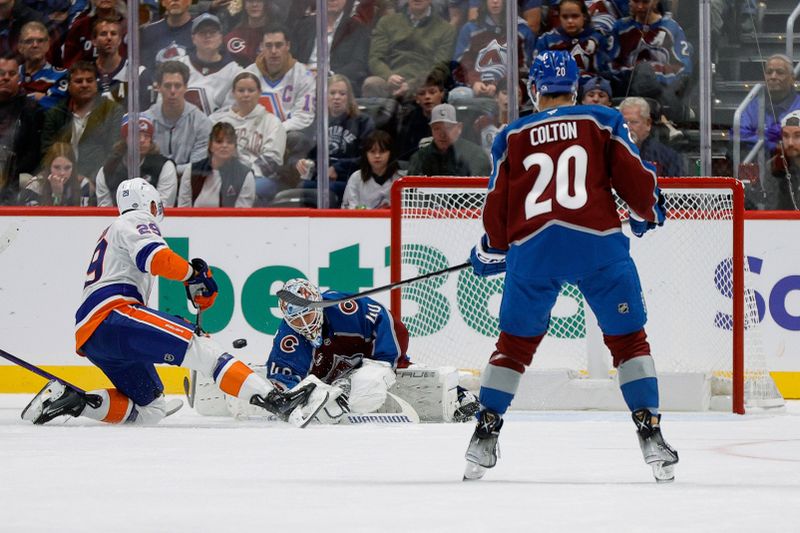 Oct 14, 2024; Denver, Colorado, USA; New York Islanders center Brock Nelson (29) scores a goal past Colorado Avalanche goaltender Alexandar Georgiev (40) as center Ross Colton (20) looks on in the second period at Ball Arena. Mandatory Credit: Isaiah J. Downing-Imagn Images