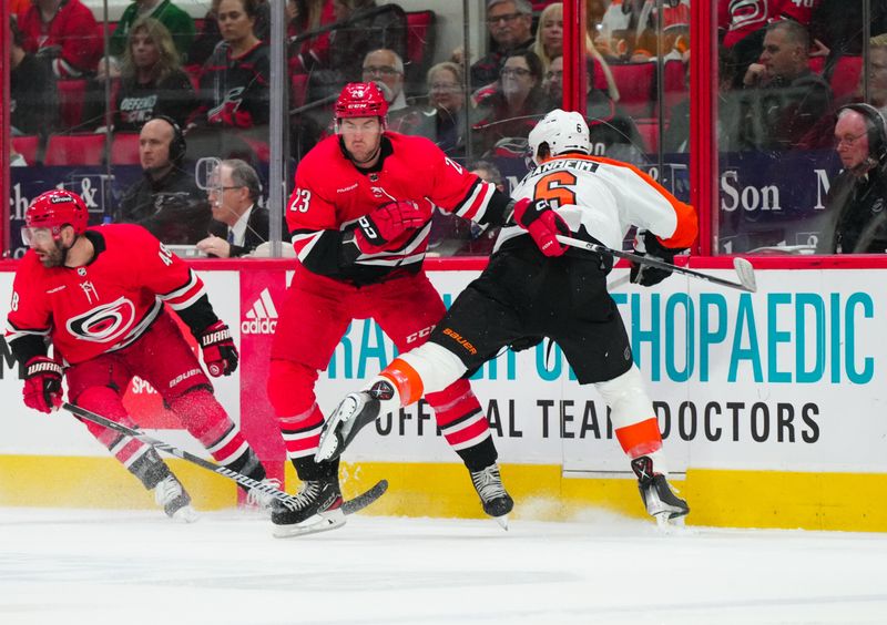 Mar 21, 2024; Raleigh, North Carolina, USA; Carolina Hurricanes right wing Stefan Noesen (23) checks Philadelphia Flyers defenseman Travis Sanheim (6) during the first period t PNC Arena. Mandatory Credit: James Guillory-USA TODAY Sports