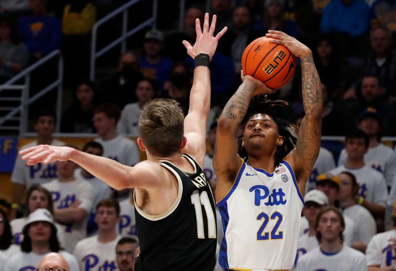 Jan 25, 2023; Pittsburgh, Pennsylvania, USA;  Pittsburgh Panthers guard Nike Sibande (22) shoots a three point basket against Wake Forest Demon Deacons forward Andrew Carr (11) during the first half at the Petersen Events Center. Mandatory Credit: Charles LeClaire-USA TODAY Sports