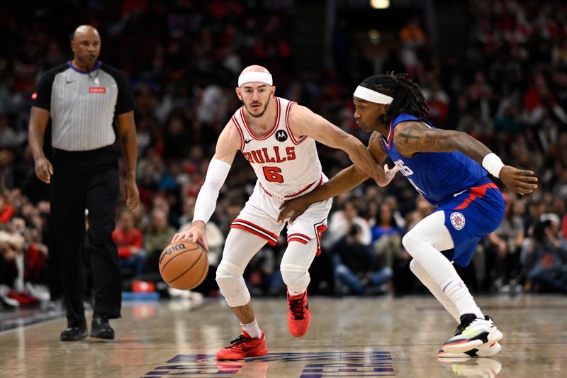 CHICAGO, ILLINOIS - MARCH 14: Alex Caruso #6 of the Chicago Bulls drives with the basketball in the first half against Terance Mann #14 of the LA Clippers at the United Center on March 14, 2024 in Chicago, Illinois.  NOTE TO USER: User expressly acknowledges and agrees that, by downloading and or using this photograph, User is consenting to the terms and conditions of the Getty Images License Agreement.  (Photo by Quinn Harris/Getty Images)