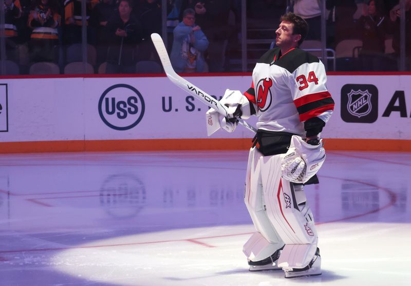 Jan 8, 2026; Pittsburgh, Pennsylvania, USA;  New Jersey Devils goaltender Jake Allen (34) stands for the national anthem against the Pittsburgh Penguins at PPG Paints Arena. Mandatory Credit: Charles LeClaire-Imagn Images