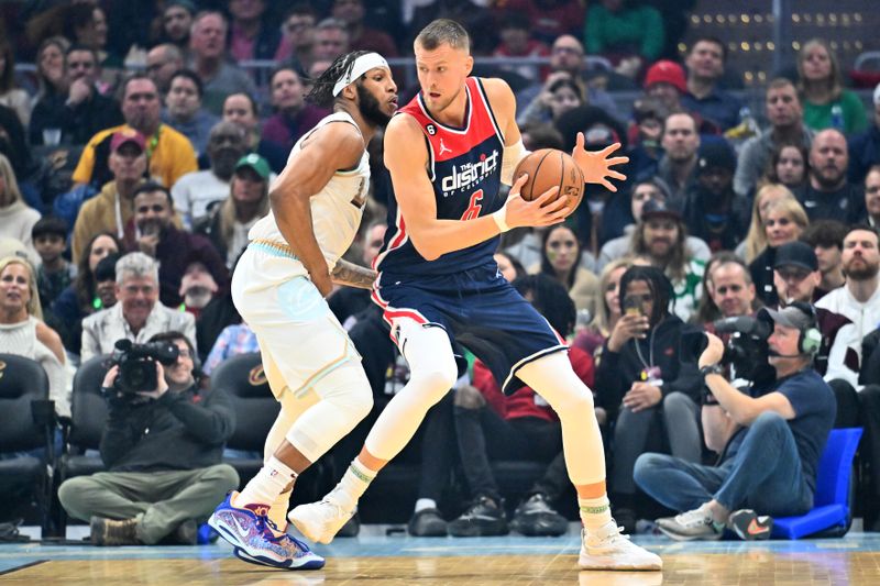 CLEVELAND, OHIO - MARCH 17: Lamar Stevens #8 of the Cleveland Cavaliers guards Kristaps Porzingis #6 of the Washington Wizards during the first half of the game at Rocket Mortgage Fieldhouse on March 17, 2023 in Cleveland, Ohio. NOTE TO USER: User expressly acknowledges and agrees that, by downloading and or using this photograph, User is consenting to the terms and conditions of the Getty Images License Agreement. (Photo by Jason Miller/Getty Images)