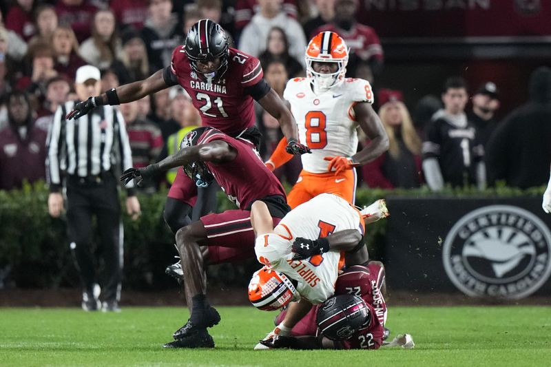 Nov 25, 2023; Columbia, South Carolina, USA; Clemson Tigers running back Will Shipley (1) is tackled by South Carolina Gamecocks linebacker Bam Martin-Scott (22) in the second half at Williams-Brice Stadium. Mandatory Credit: David Yeazell-USA TODAY Sports