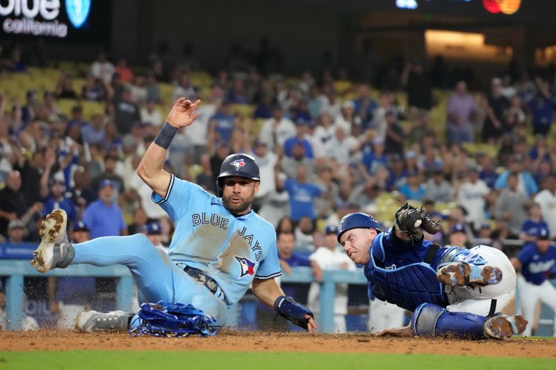 Jul 25, 2023; Los Angeles, California, USA; Los Angeles Dodgers catcher Will Smith (16) tags out Toronto Blue Jays center fielder Kevin Kiermaier (39) out at home plate in the 10th inning at Dodger Stadium. Mandatory Credit: Kirby Lee-USA TODAY Sports