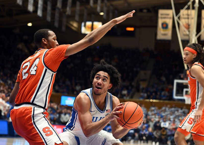 Jan 2, 2024; Durham, North Carolina, USA;  Duke Blue Devils guard Jared McCain (0) looks to shoot as Syracuse Orange guard Quadir Copeland (24) defends during the second half at Cameron Indoor Stadium.  The Blue Devils won 86-66. Mandatory Credit: Rob Kinnan-USA TODAY Sports