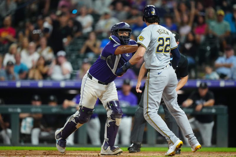 Jul 1, 2024; Denver, Colorado, USA; Colorado Rockies catcher Elias Diaz (35) tags out Milwaukee Brewers outfielder Christian Yelich (22) in the tenth inning at Coors Field. Mandatory Credit: Ron Chenoy-USA TODAY Sports