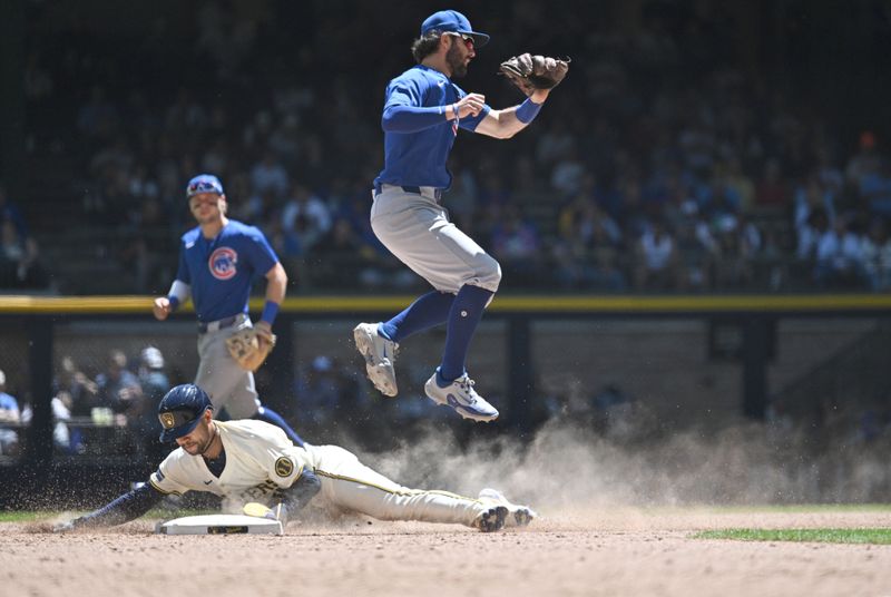 May 30, 2024; Milwaukee, Wisconsin, USA; Milwaukee Brewers outfielder Blake Perkins (16) slides in safely to second base against Chicago Cubs shortstop Dansby Swanson (7) in the seventh inning at American Family Field. Mandatory Credit: Michael McLoone-USA TODAY Sports