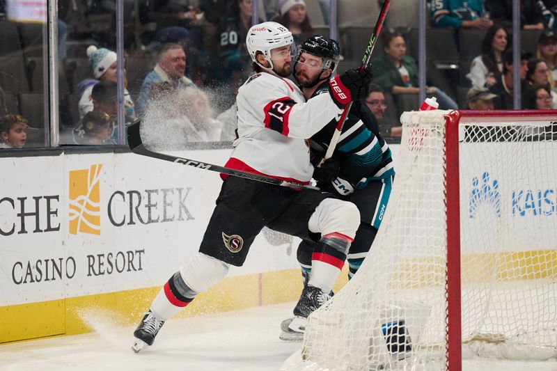 Mar 9, 2024; San Jose, California, USA: San Jose Sharks defenseman Marc-Edouard Vlasic (44) checks Ottawa Senators center Mark Kastelic (12) behind the net during the first period at SAP Center at San Jose. Mandatory Credit: Robert Edwards-USA TODAY Sports