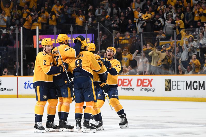 Mar 2, 2024; Nashville, Tennessee, USA; Nashville Predators players celebrate with center Cody Glass (8) after scoring a hat trick during the third period against the Colorado Avalanche at Bridgestone Arena. Mandatory Credit: Christopher Hanewinckel-USA TODAY Sports