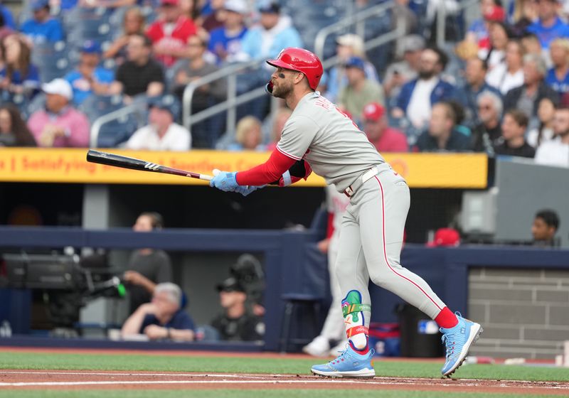 Jun 3, 2025; Toronto, Ontario, CAN; Philadelphia Phillies first baseman Bryce Harper (3) reacts after hitting a home run against the Toronto Blue Jays during the first inning at Rogers Centre. Mandatory Credit: Nick Turchiaro-Imagn Images