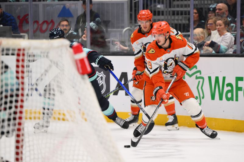 Nov 27, 2024; Seattle, Washington, USA; Anaheim Ducks right wing Troy Terry (19) plays the puck during the second period against the Seattle Kraken at Climate Pledge Arena. Mandatory Credit: Steven Bisig-Imagn Images