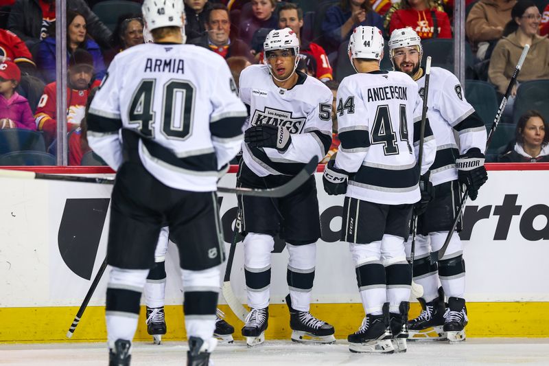 Mar 24, 2026; Calgary, Alberta, CAN; Los Angeles Kings right wing Quinton Byfield (55) celebrates his goal with teammates against the Calgary Flames during the first period at Scotiabank Saddledome. Mandatory Credit: Sergei Belski-Imagn Images