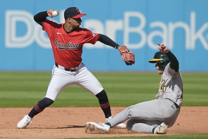 Apr 21, 2024; Cleveland, Ohio, USA; Cleveland Guardians shortstop Brayan Rocchio (4) forces out Oakland Athletics shortstop Nick Allen (10) and turns the double play during the ninth inning at Progressive Field. Mandatory Credit: Ken Blaze-USA TODAY Sports