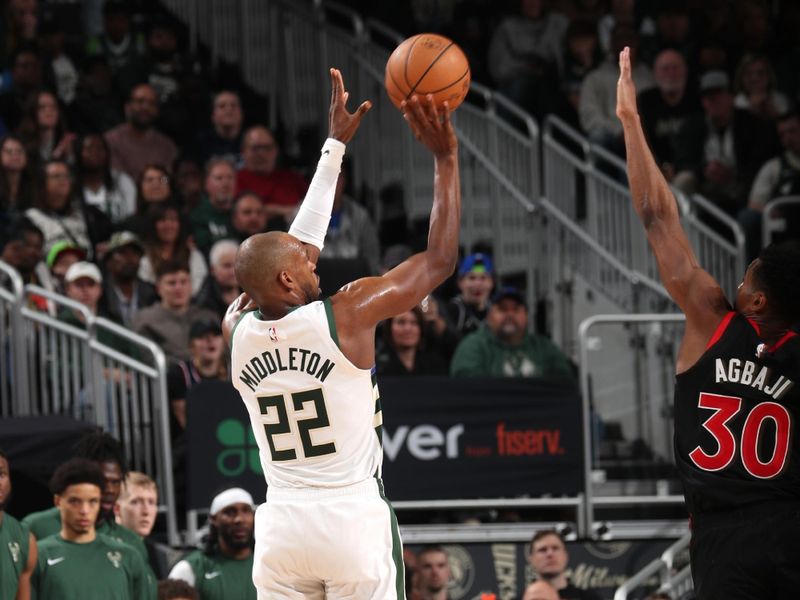 MILWAUKEE, WI - APRIL 5: Khris Middleton #22 of the Milwaukee Bucks shoots the ball during the game against the Toronto Raptors on April 5, 2024 at the Fiserv Forum Center in Milwaukee, Wisconsin. NOTE TO USER: User expressly acknowledges and agrees that, by downloading and or using this Photograph, user is consenting to the terms and conditions of the Getty Images License Agreement. Mandatory Copyright Notice: Copyright 2024 NBAE (Photo by Gary Dineen/NBAE via Getty Images).