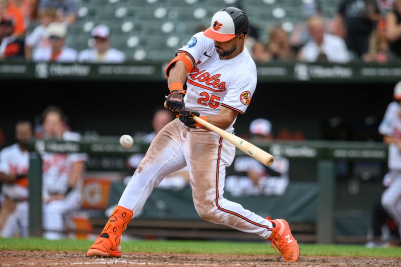 Jul 31, 2024; Baltimore, Maryland, USA; Baltimore Orioles outfielder Anthony Santander (25) hits a single against the Toronto Blue Jays during the fifth inning at Oriole Park at Camden Yards. Mandatory Credit: Reggie Hildred-USA TODAY Sports