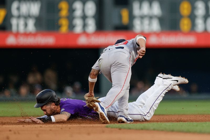 Jul 22, 2024; Denver, Colorado, USA; Colorado Rockies right fielder Jake Cave (11) is tagged out attempting to steal second against Boston Red Sox second baseman Jamie Westbrook (73) in the fifth inning at Coors Field. Mandatory Credit: Isaiah J. Downing-USA TODAY Sports