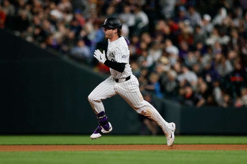 Aug 9, 2024; Denver, Colorado, USA; Colorado Rockies third baseman Ryan McMahon (24) runs to second on an RBI double in the seventh inning against the Atlanta Braves at Coors Field. Mandatory Credit: Isaiah J. Downing-USA TODAY Sports