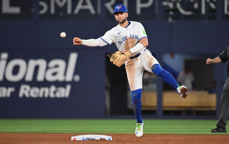 May 14, 2025; Toronto, Ontario, CAN;  Toronto Blue Jays shortstop Bo Bichette (11) throws out Tampa Bay Rays left fielder Chandler Simpson (not shown) in the fifth inning at Rogers Centre. Mandatory Credit: Dan Hamilton-Imagn Images