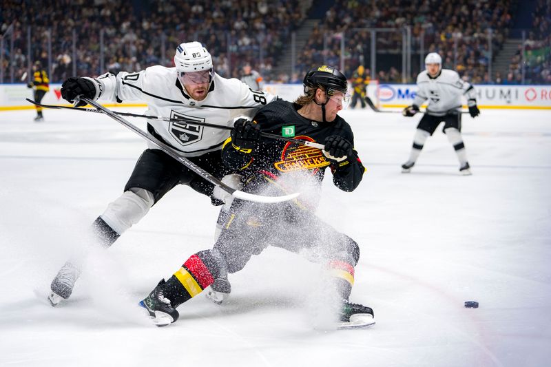 Mar 25, 2024; Vancouver, British Columbia, CAN; Los Angeles Kings forward Pierre-Luc Dubois (80) checks Vancouver Canucks forward Brock Boeser (6) in the third period at Rogers Arena. Kings won 3 -2. Mandatory Credit: Bob Frid-USA TODAY Sports