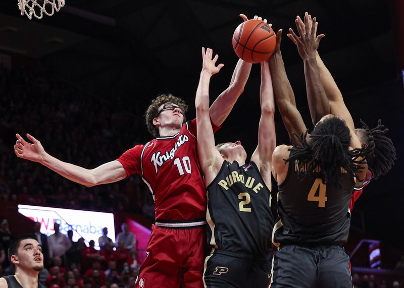 Jan 28, 2024; Piscataway, New Jersey, USA; Rutgers Scarlet Knights guard Gavin Griffiths (10) and center Clifford Omoruyi (11) rebound against Purdue Boilermakers guard Fletcher Loyer (2) and forward Trey Kaufman-Renn (4) during the second half at Jersey Mike's Arena. Mandatory Credit: Vincent Carchietta-USA TODAY Sports