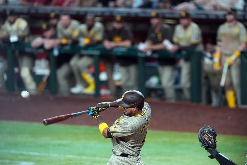 May 4, 2024; Phoenix, Arizona, USA; San Diego Padres designated hitter Luis Arraez (4) hits a single against the Arizona Diamondbacks during the seventh inning at Chase Field. Mandatory Credit: Joe Camporeale-USA TODAY Sports