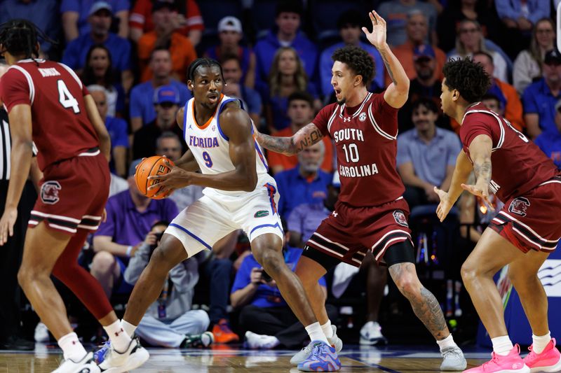 Feb 17, 2026; Gainesville, Florida, USA; Florida Gators center Rueben Chinyelu (9) posts up against South Carolina Gamecocks forward Myles Stute (10) during the first half at Exactech Arena at the Stephen C. O'Connell Center. Mandatory Credit: Matt Pendleton-Imagn Images