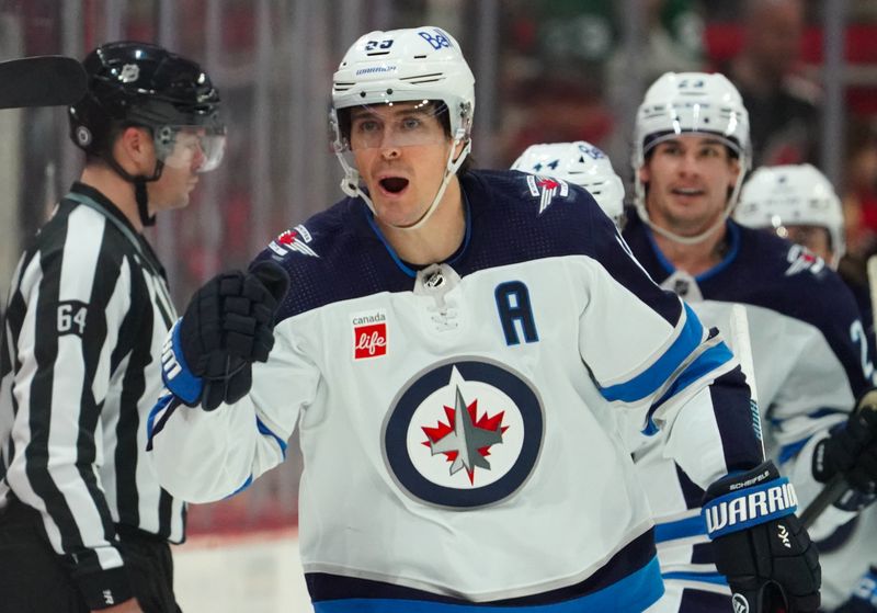 Mar 2, 2024; Raleigh, North Carolina, USA; Winnipeg Jets center Mark Scheifele (55) celebrates his goal against the Carolina Hurricanes during the third period at PNC Arena. Mandatory Credit: James Guillory-USA TODAY Sports