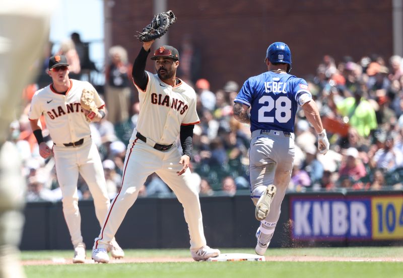 May 21, 2025; San Francisco, California, USA; San Francisco Giants first baseman LaMonte Wade Jr. (31) makes na out against Kansas City Royals center fielder Kyle Isbel (28) during the fifth inning at Oracle Park. Mandatory Credit: Kelley L Cox-Imagn Images