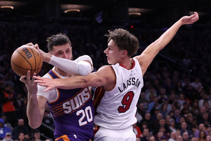 PHOENIX, ARIZONA - NOVEMBER 06: Jusuf Nurkic #20 of the Phoenix Suns and Pelle Larsson #9 of the Miami Heat battle for a rebound during the second half at Footprint Center on November 06, 2024 in Phoenix, Arizona. NOTE TO USER: User expressly acknowledges and agrees that, by downloading and or using this photograph, User is consenting to the terms and conditions of the Getty Images License Agreement.  (Photo by Chris Coduto/Getty Images)