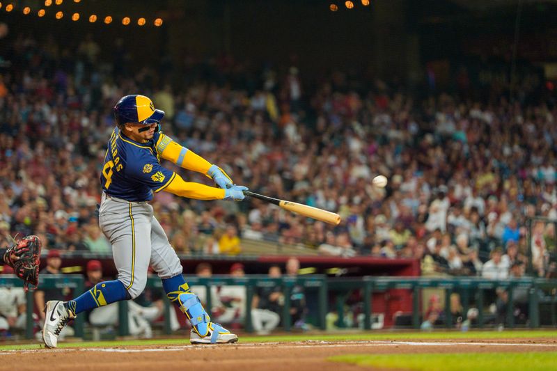 Apr 13, 2025; Phoenix, Arizona, USA;  Milwaukee Brewers catcher William Contreras (24) hits a home run in the second inning against the Arizona Diamondbacks at Chase Field. Mandatory Credit: Allan Henry-Imagn Images