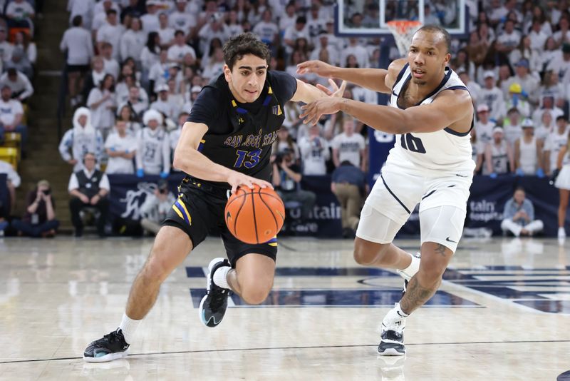 Jan 30, 2024; Logan, Utah, USA; San Jose State Spartans guard Alvaro Cardenas (13) drives against Utah State Aggies guard Darius Brown II (10) during the first half during the first half at Dee Glen Smith Spectrum. Mandatory Credit: Rob Gray-USA TODAY Sports